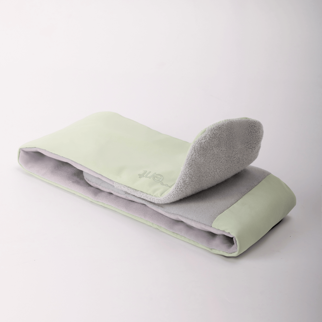 Deep Rest Sleep Mask folded open to show both sides, Honeydew Green on one and soft grey on the other, with its strap
